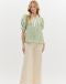 Woman wearing a mint green floral Entro top with puff sleeves and peplum hem

